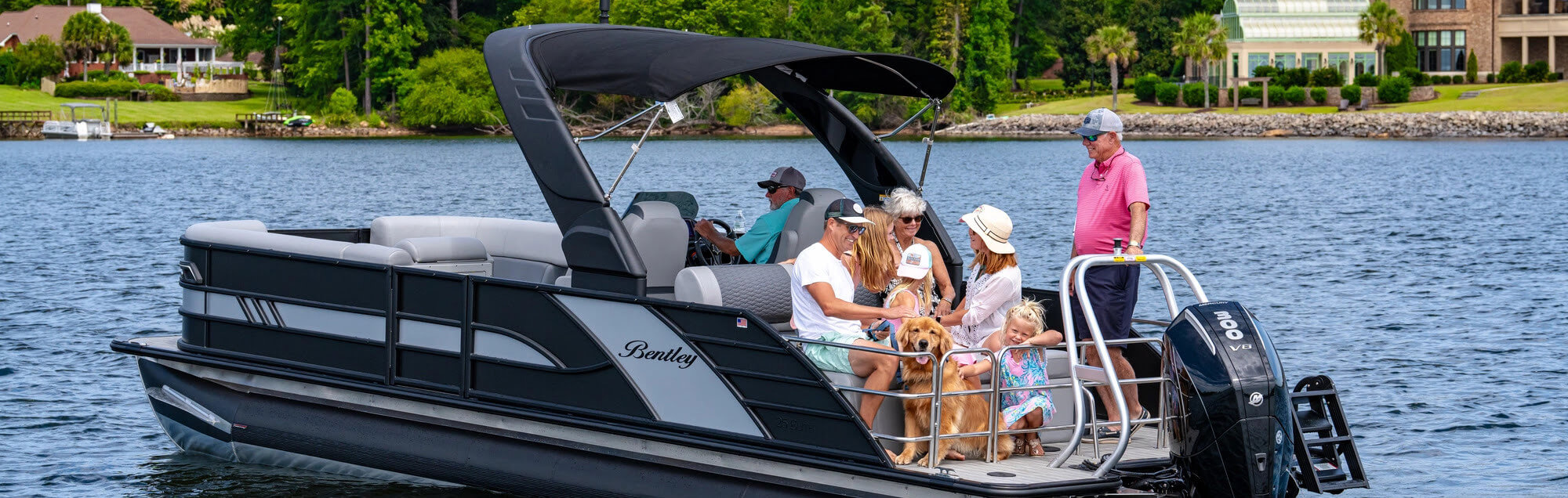 A family on a pontoon boat on a lake.